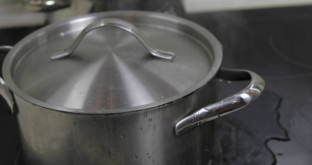 istock Boiling Water In The Pan that is covered with a lid in the kitchen 1151487391