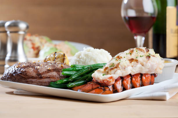 surf and turf - steak dinner lobster wine imagens e fotografias de stock