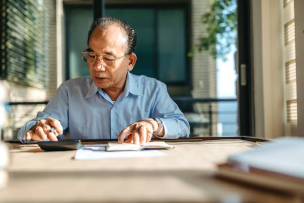 istock Senior Taiwanese man making a financial plan 1151495105