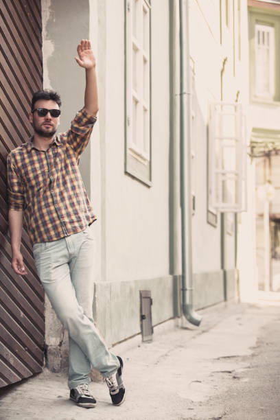 istock Young man standing on the street waving 1151496272