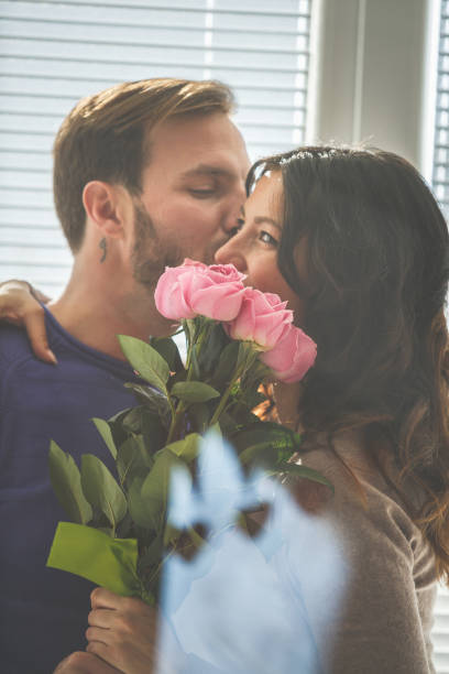 istock Couple with pink roses kissing 1151496690