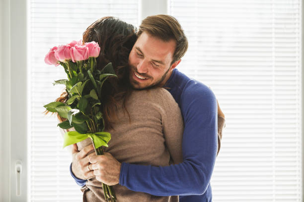 istock Man giving roses to his wife 1151496797