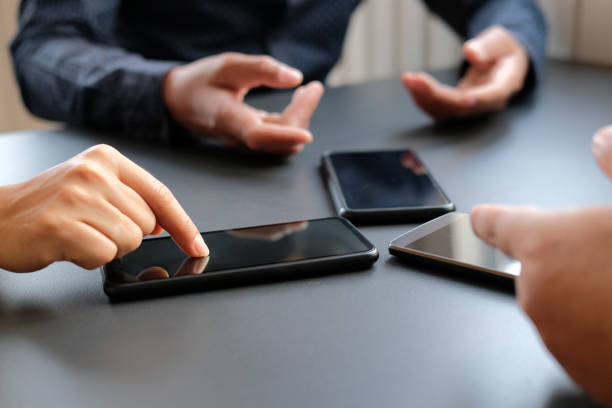 istock business people discussing using smart mobile phone 1151497181