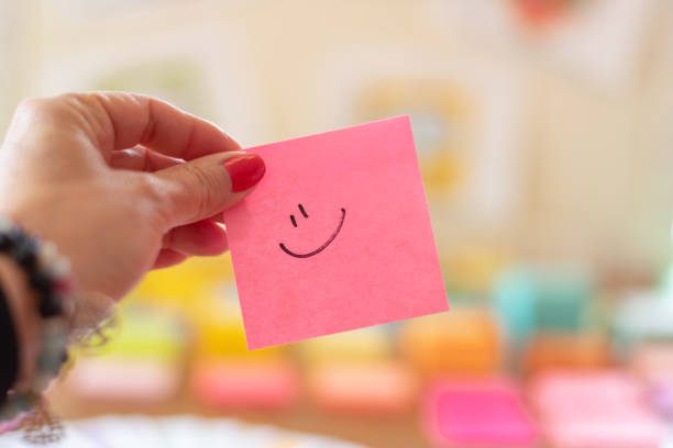 Pink sticky note with smiley face stock photo