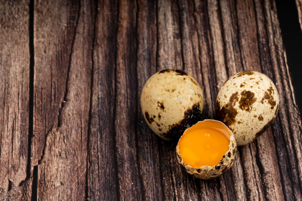 mottled quail eggs on old wooden