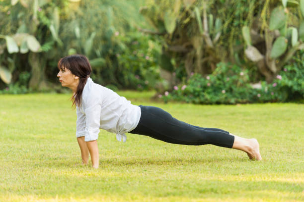 istock Mature woman practicing yoga in nature 1151502552