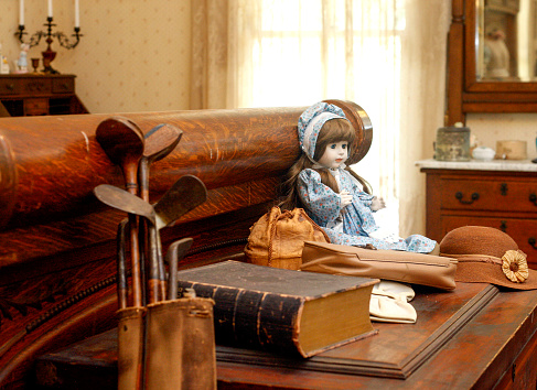 Doll and Golf clubs in an old home.