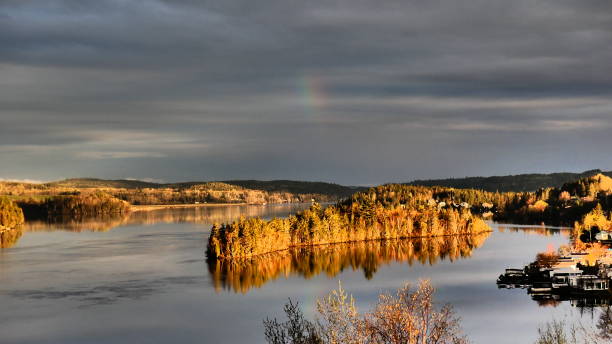 istock Sunrise that illuminates the island on the River under a cloudy sky 1151507187