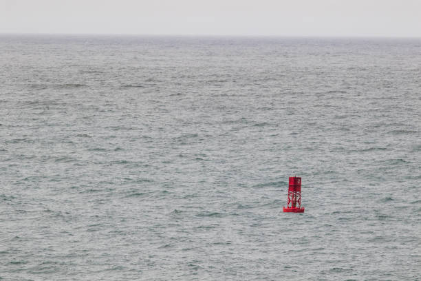istock a red ocean buoy in dark weather 1151508805