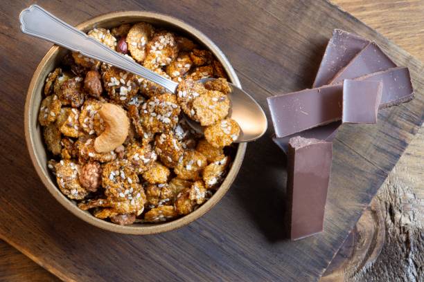 istock Bowl with granola and dark chocolate bar. 1151511399