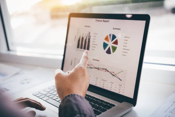 istock Investors man pointing laptop computers to analyze graphs in the morning. 1151511599