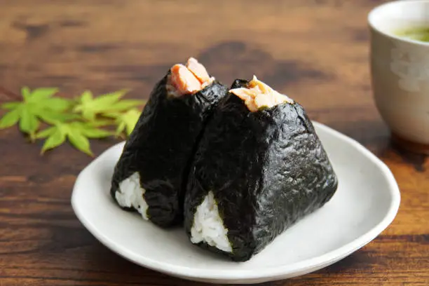 Rice ball of salmon.Rice ball is a Japanese food made from white rice, seaweed and fillings.