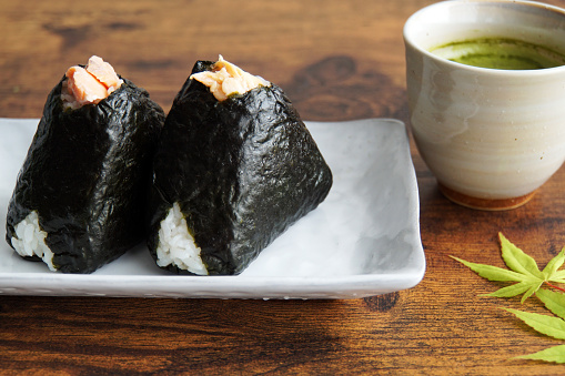 Rice ball of salmon.Rice ball is a Japanese food made from white rice, seaweed and fillings.