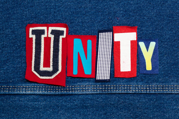 istock UNITY word collage from cut out tee shirt letters on denim, team building 1151512361
