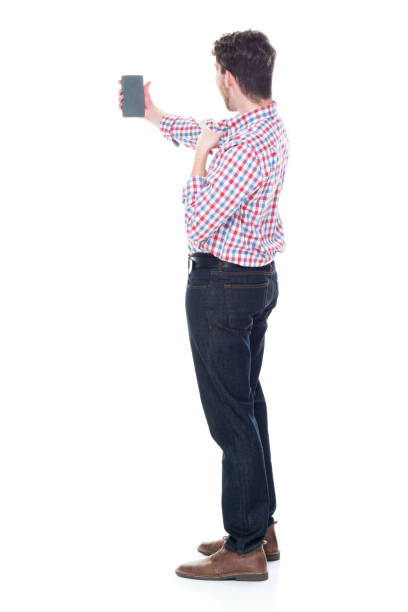 istock Attractive young man wearing a checked shirt and jeans - taking a selfie 1151513101