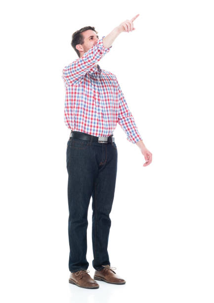 istock Attractive young man wearing a checked shirt and jeans - pointing up 1151514068