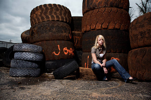 istock blonde female tire dump portraits 115151409