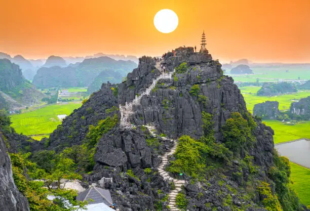 Mua Cave mountain viewpoint, Stunning view of Tam Coc area with mountain range, rice fields. It is such as Great Wall in Ninh Binh, Vietnam