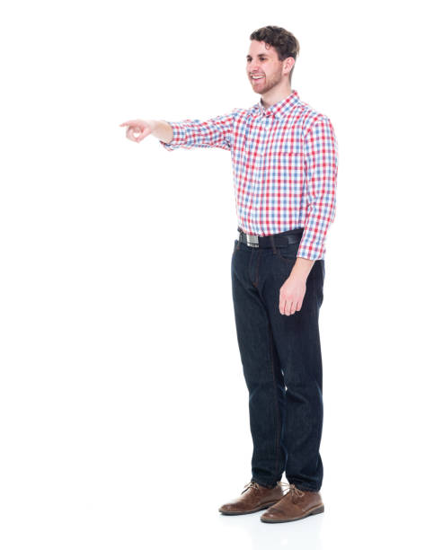 istock Attractive young man wearing a checked shirt and jeans - pointing 1151515560