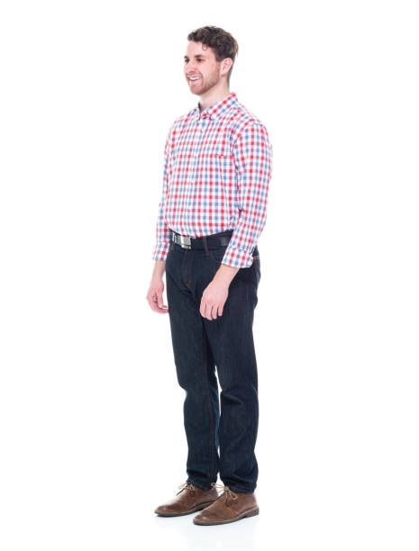istock Attractive young man wearing a checked shirt and jeans - hands by side 1151516431