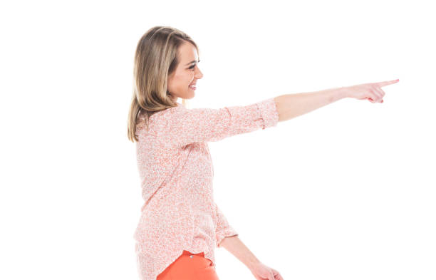 istock Beautiful white female in bright clothes - pointing ahead 1151519877