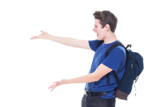 istock Young high school age male student is showing to the side 1151522971