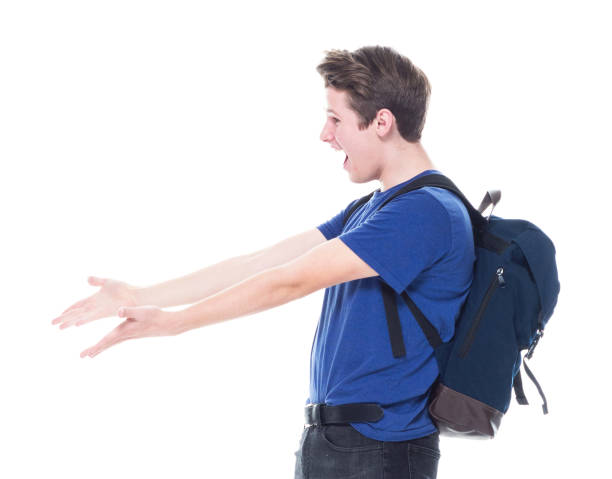 istock Young high school age male student is showing to the side 1151522976