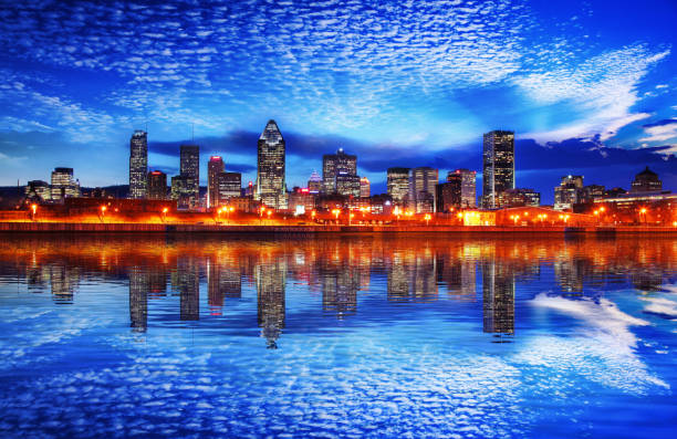 Montreal Cityscape Reflection at Sunset Illuminated Montreal Cityscape at Night buzbuzzer montreal city stock pictures, royalty-free photos & images