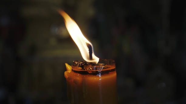 istock Burning candle on a black background. One burning candle on a black background 1151526335
