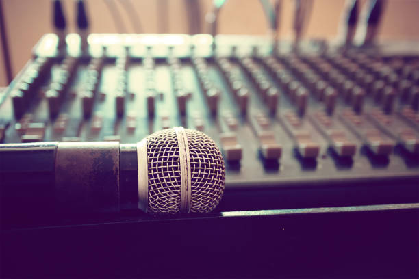 istock Microphone in front of blurry sound mixer 1151527179