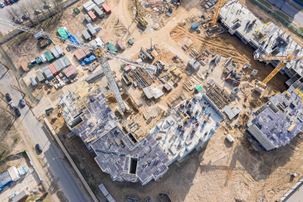 istock birds eye view of construction site with cranes and unfinished building 1151528169