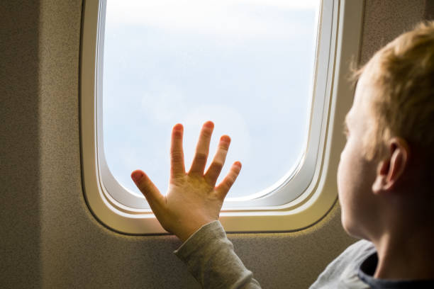 istock Close-up of boy looking through window 1151529345