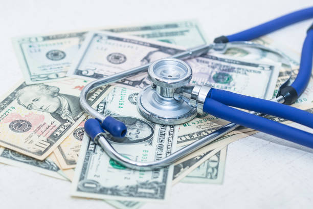 istock The blue stethoscope is on the messy dollar 1151535594
