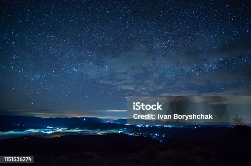 istock Starry sky over the city in the fog 1151536274