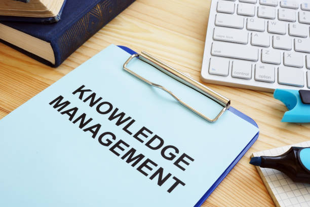 istock Knowledge management concept. Clipboard and books on table. 1151539610