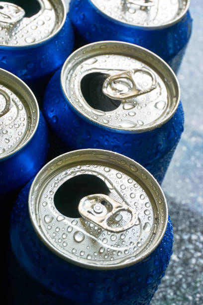 Close up of blue soda cans with open pull tab