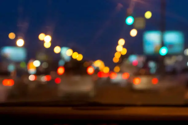 defocused city night street view from car front window