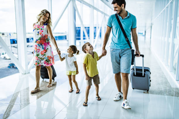 istock Happy family talking while walking through airport hallway. 1151547656