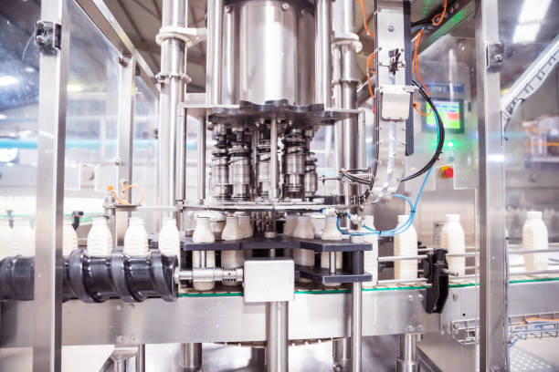 Automatic Milk Bottling Factory in Africa Africa, Industry, Business, Factory, Automatic - Fully Automatic Machine Filling the Fresh Milk in the Bottles bottling plant stock pictures, royalty-free photos & images