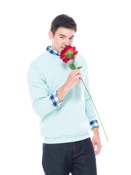 istock Attractive man is holding a red rose 1151551415