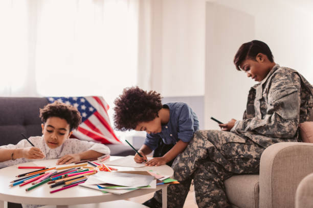 African - American Army Mom African-American army mom drawing with her child at home. proud army mom stock pictures, royalty-free photos & images