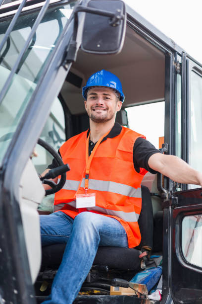 istock Portrait Of Construction Worker Driving Crane 1151551916