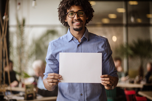 It's a space to have your say. Business man holding empty paper.