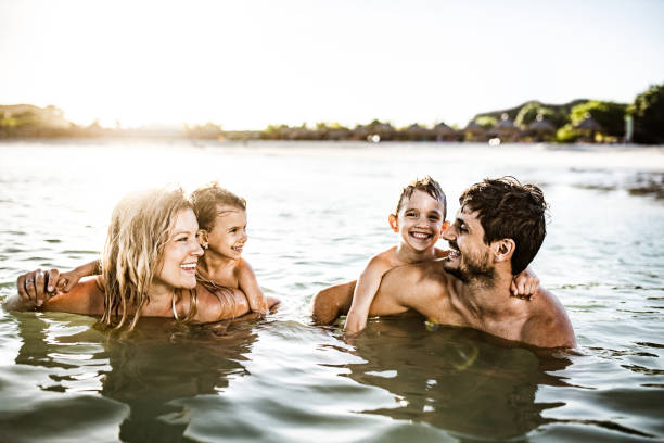 istock Young happy family talking while enjoying in sea. 1151554417