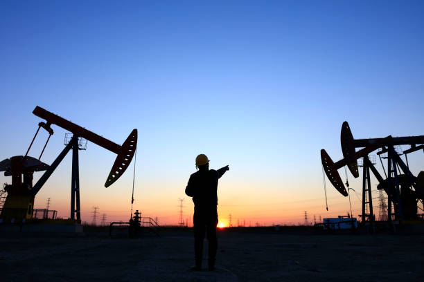 istock oil field, the oil workers are working 1151557833