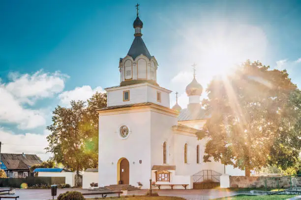 Photo of Mir, Belarus. Orthodox Church Of The Holy Trinity In Sunrise Sunrays. Famous Landmark