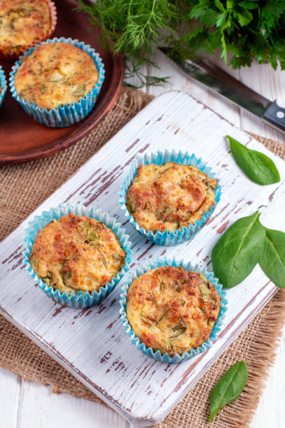 istock Muffins with spinach and cheese on a white wooden board. 1151559535