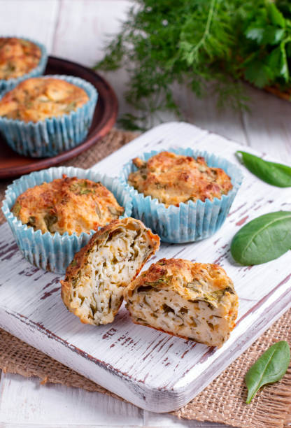 istock Muffins with spinach and cheese on a white wooden board. 1151559547