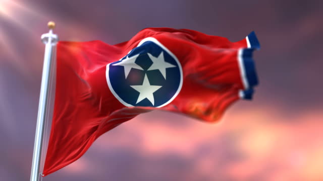 Flag of Tennessee state at sunset, region of the United States - loop