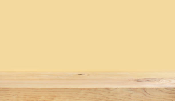 istock Empty of wood table top on yellow pastel color background 1151563571